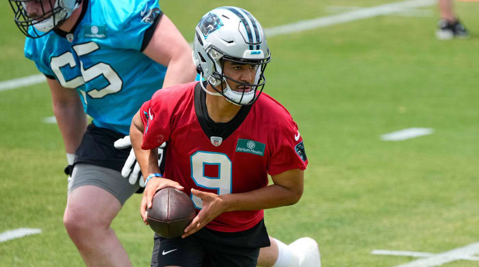 Bryce Young looks to hand the ball off during Panthers OTAs